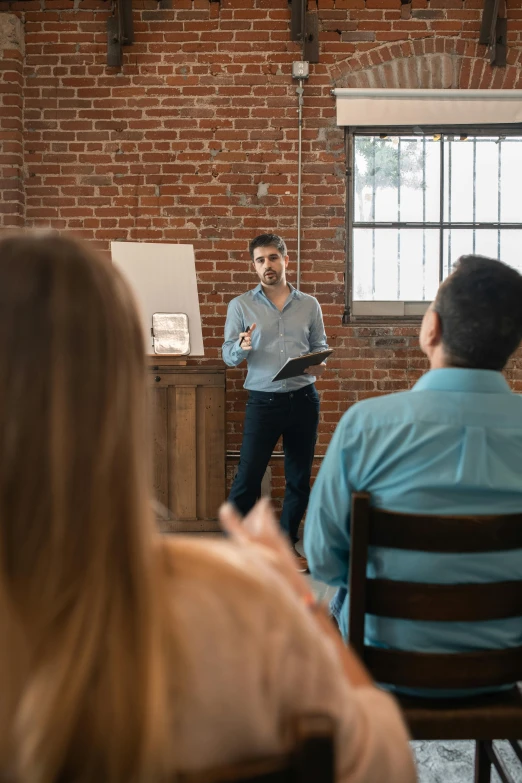 the man is in a meeting with his colleagues