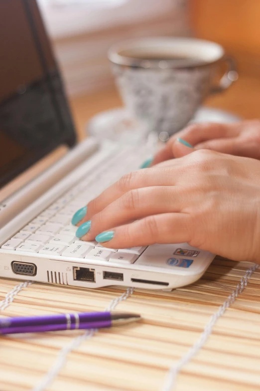 a woman uses her computer on a table