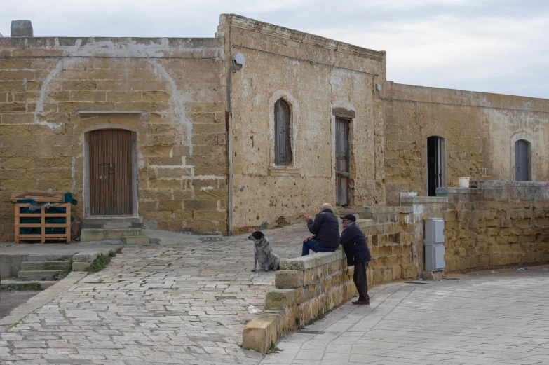 the two people are standing on a stone step