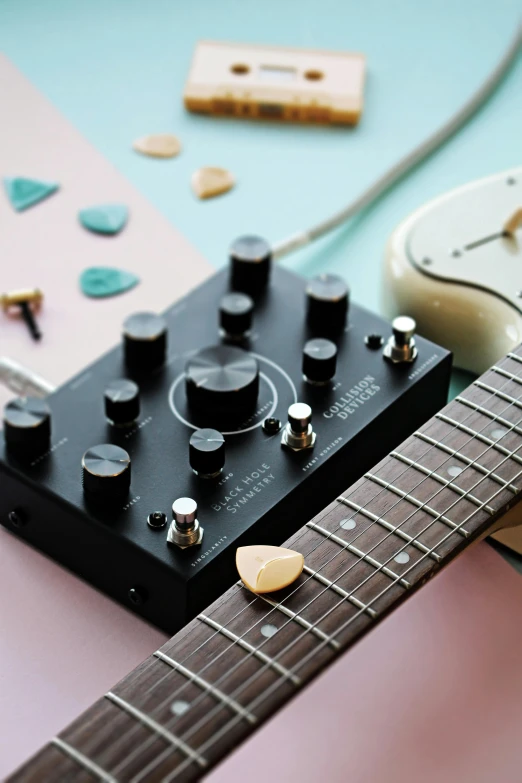 a guitar with s sits in front of other instrument items