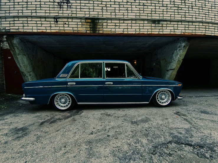 a blue car sitting in front of a building