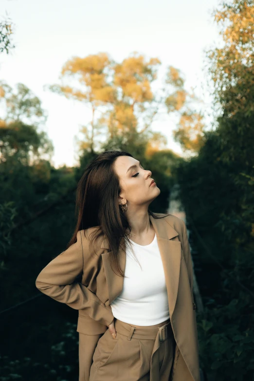 woman in jacket with head turned, staring upward