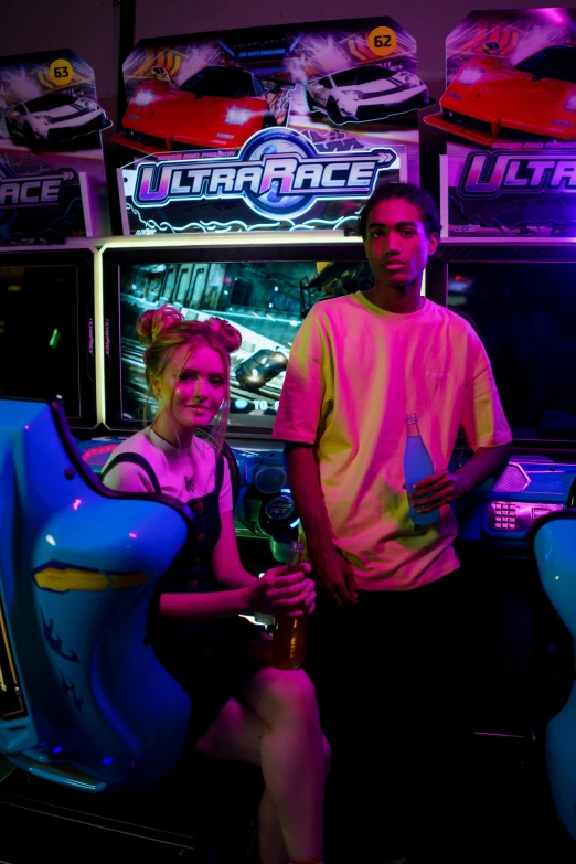 a couple posing with some arcade gaming machines