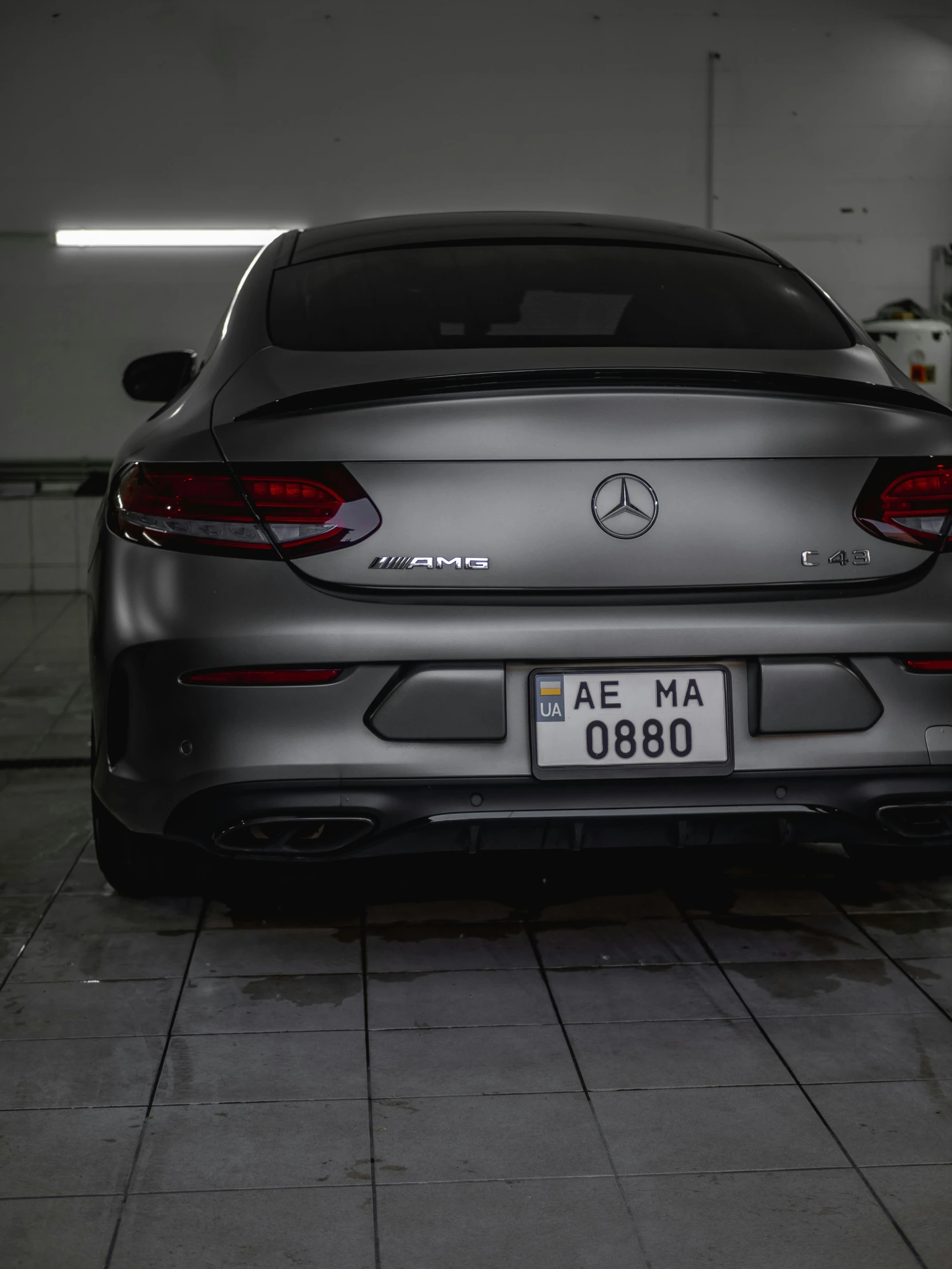 the rear end of a gray mercedes amg sedan