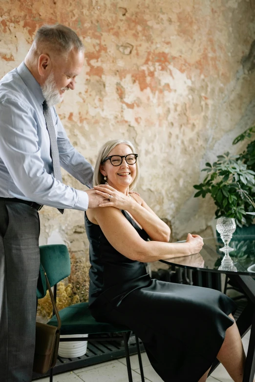 a man standing next to a woman near a table