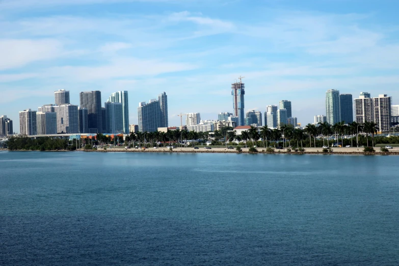 city in distance with blue water and blue sky