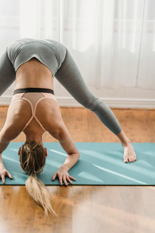 a woman is in yoga poses on the mat