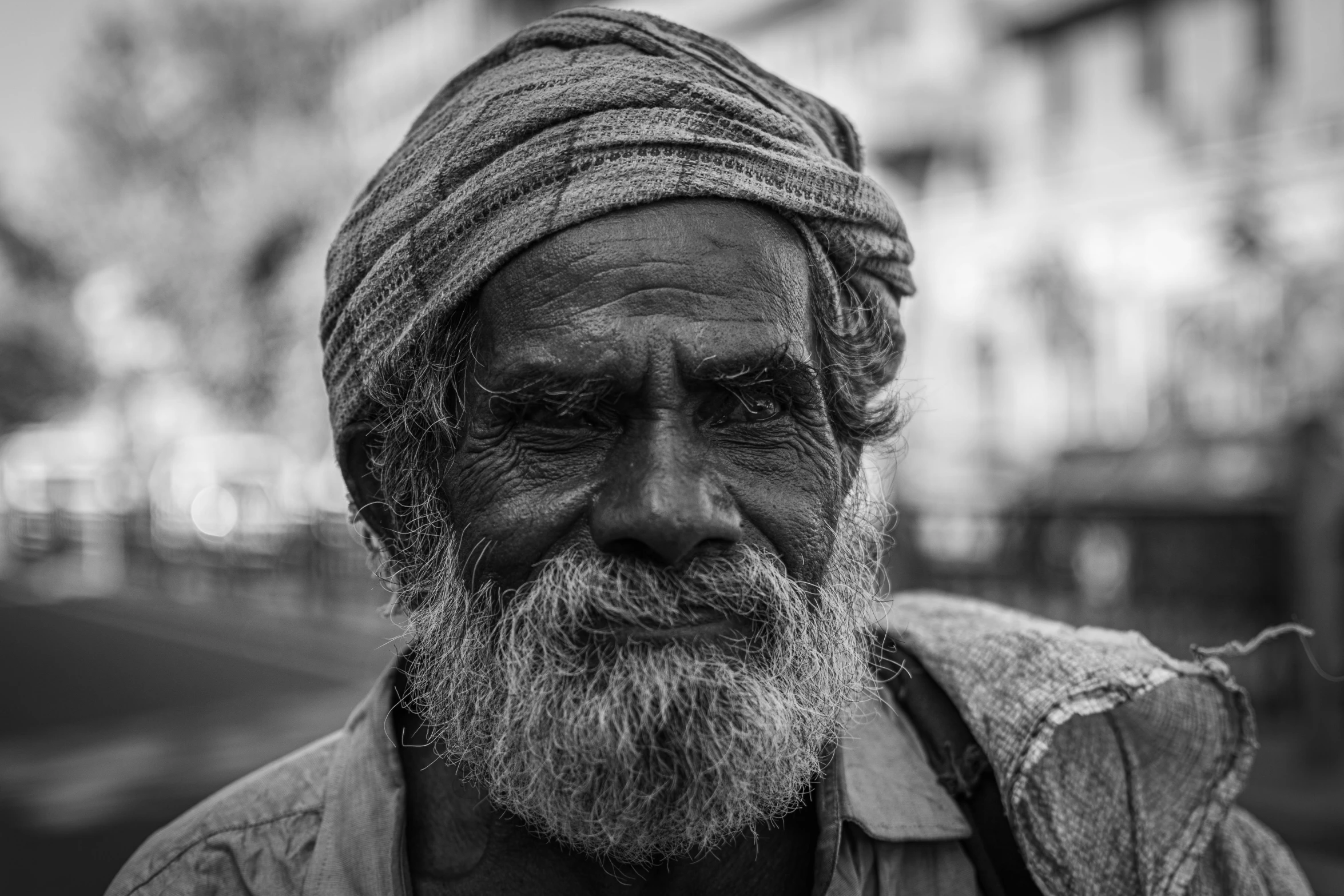 black and white pograph of man with head scarves