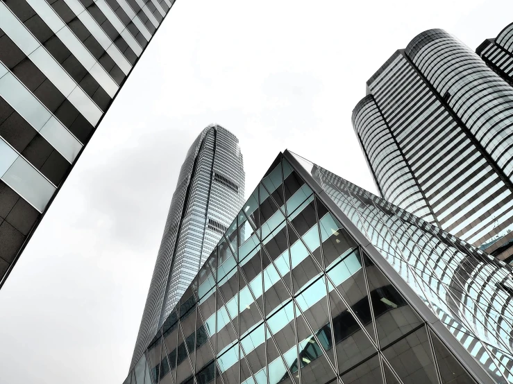 two very large buildings with many windows in front of it