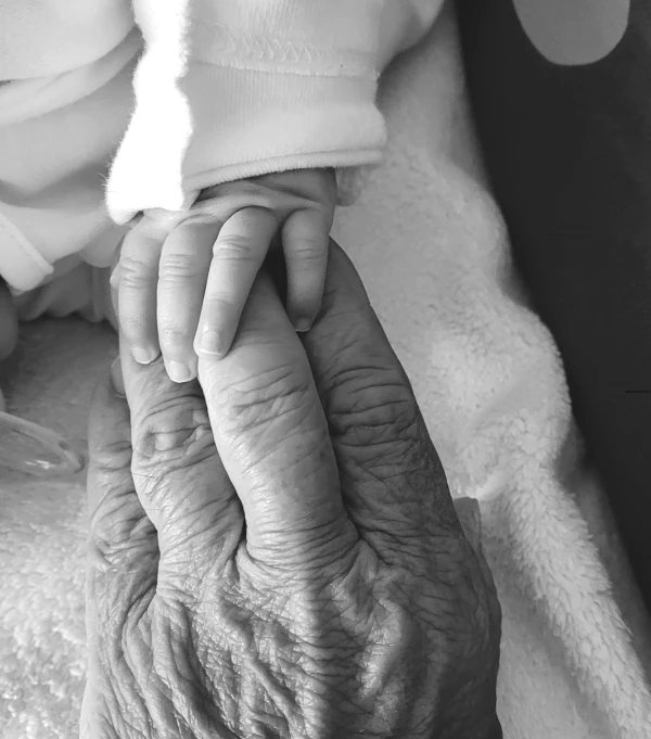 a woman holding her baby on top of her hands