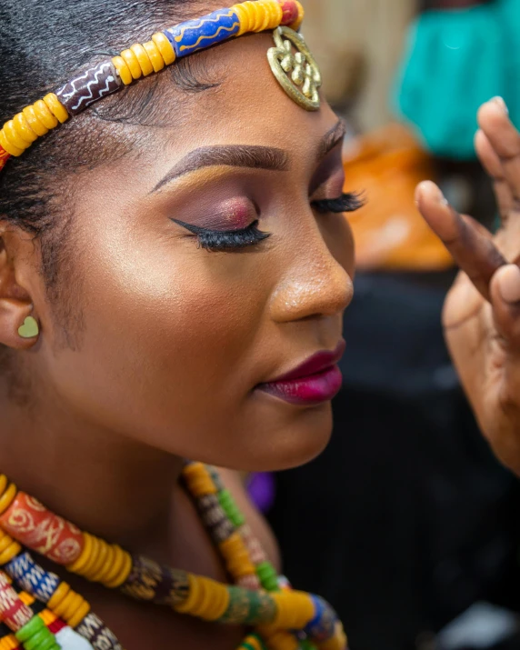 an african american woman putting her fingers in the air