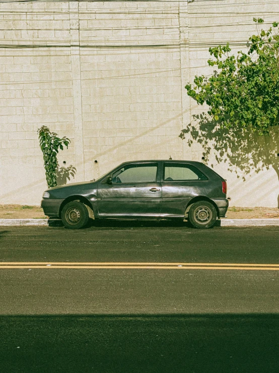 there is a small car parked next to a wall