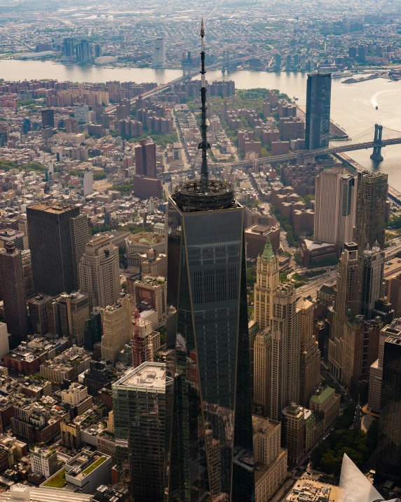 the top of a tall building surrounded by buildings and other large city buildings