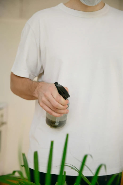 a man wearing a white shirt and holding a wine bottle