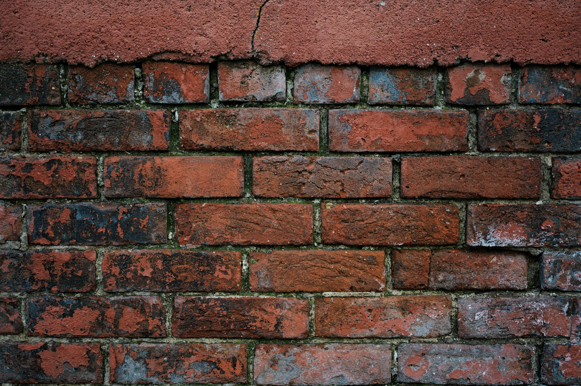 a brick wall with an old, ed y surface