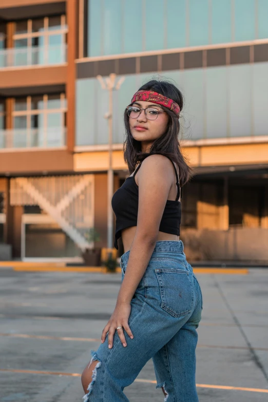 a young lady posing with her arms on her hip