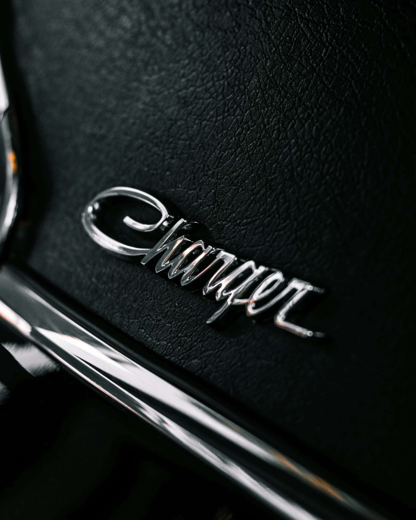 a logo of a car on a black leather