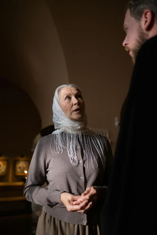 a man standing next to a woman in a dark room