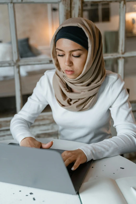 a woman with a scarf on her head and looking at soing