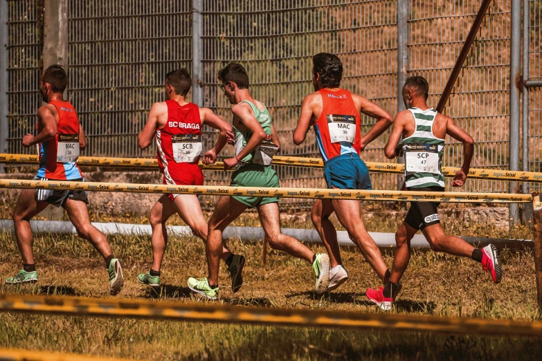 a group of people run down a track