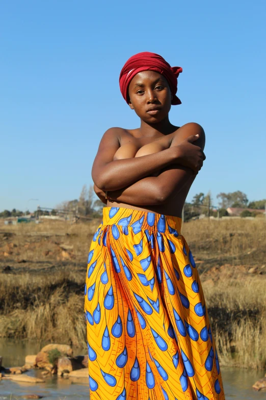 a woman in a long skirt with her arms crossed