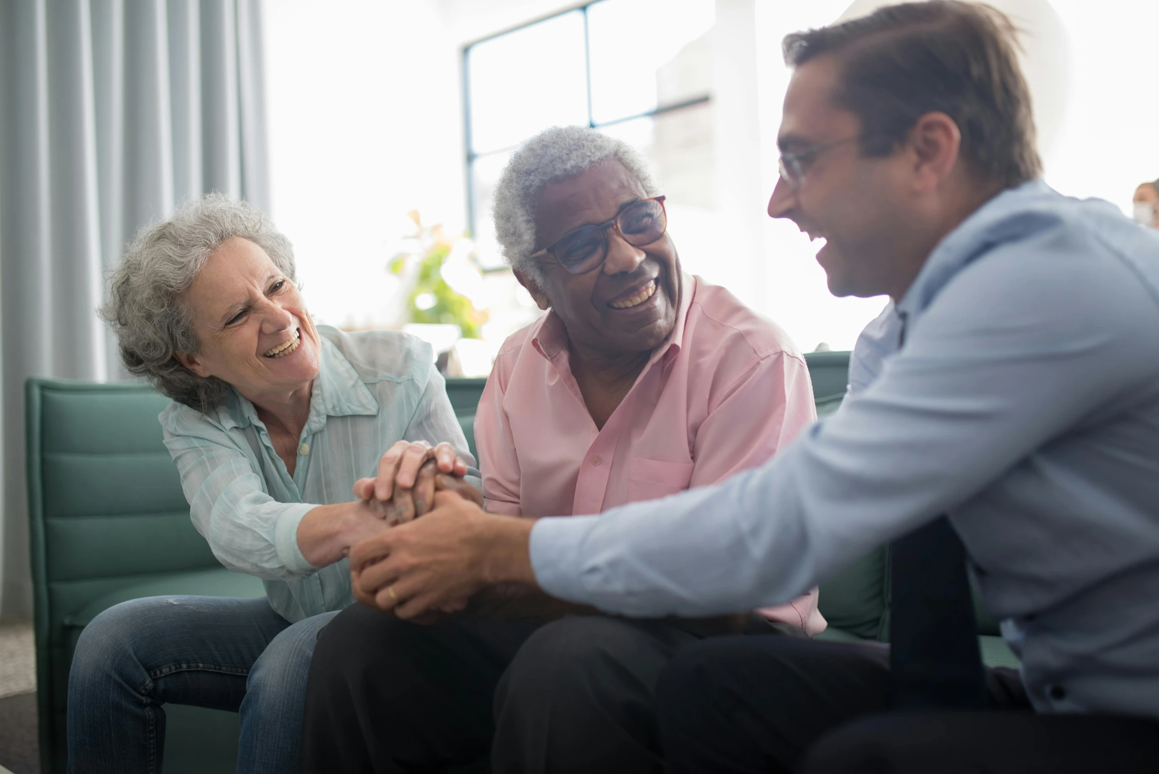 two men and an elderly woman are talking