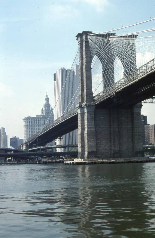 an old looking bridge that is spanning over water