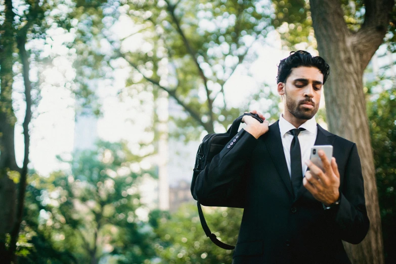 a man wearing a suit holding a camera