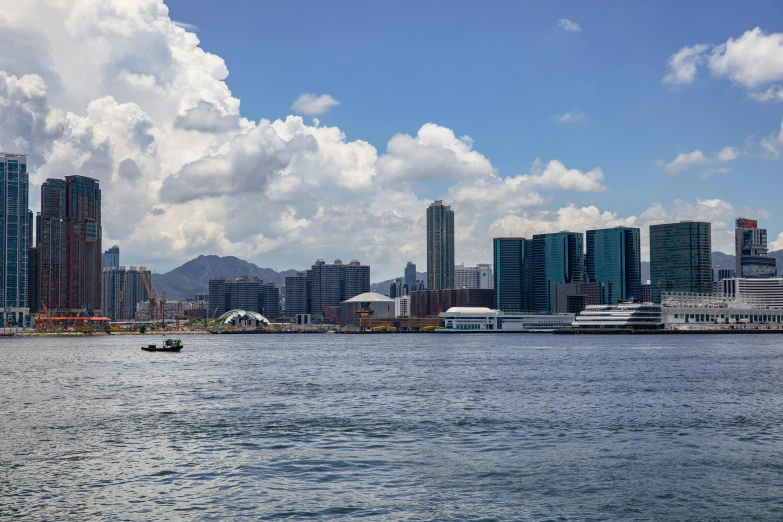 a boat in the water with tall buildings near by