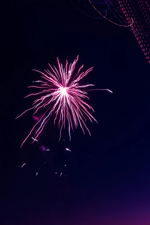 the colorful firework is lit up in the night sky