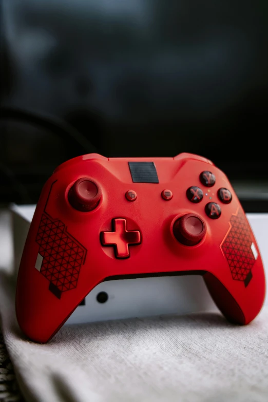 a red controller on a white cloth