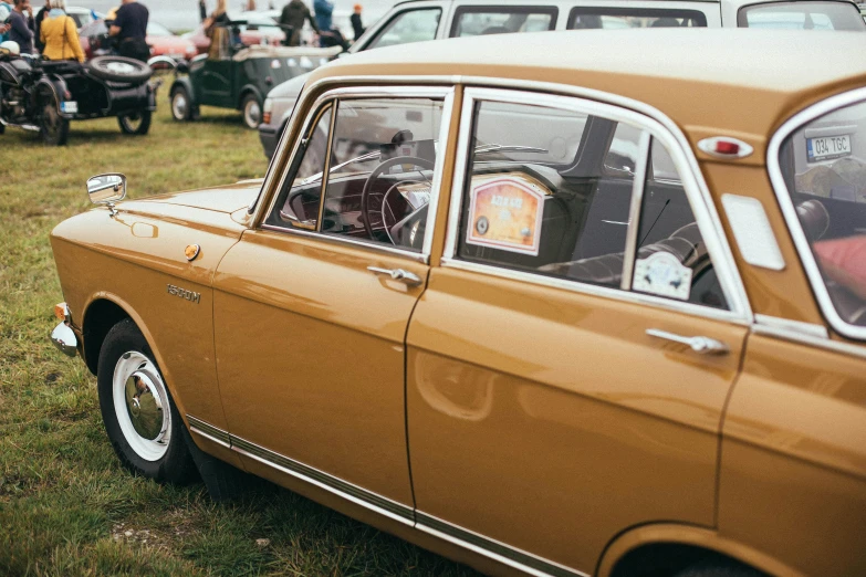 an old car that is parked in the grass