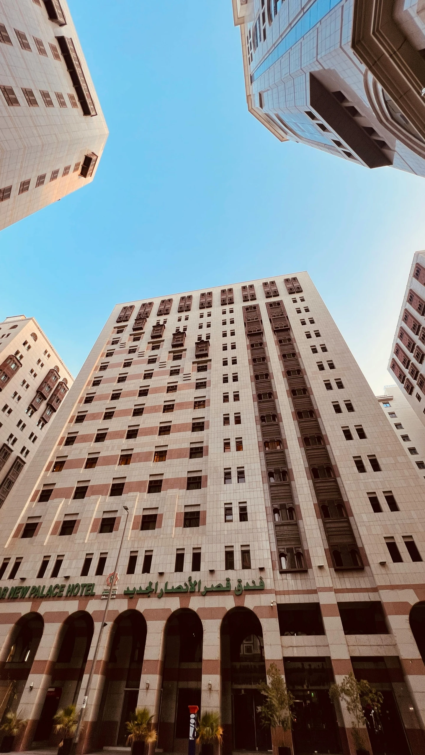 two tall buildings towering in the air, one has a clock on it