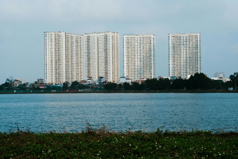 some buildings on the water with some green plants