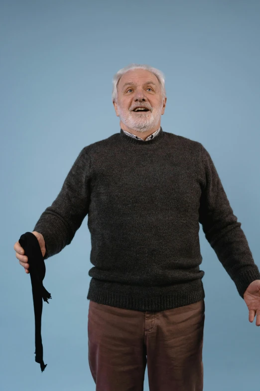 an old man holding his hands open, is standing in a pose