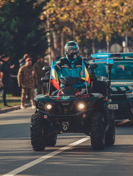 a man drives an atv through the streets