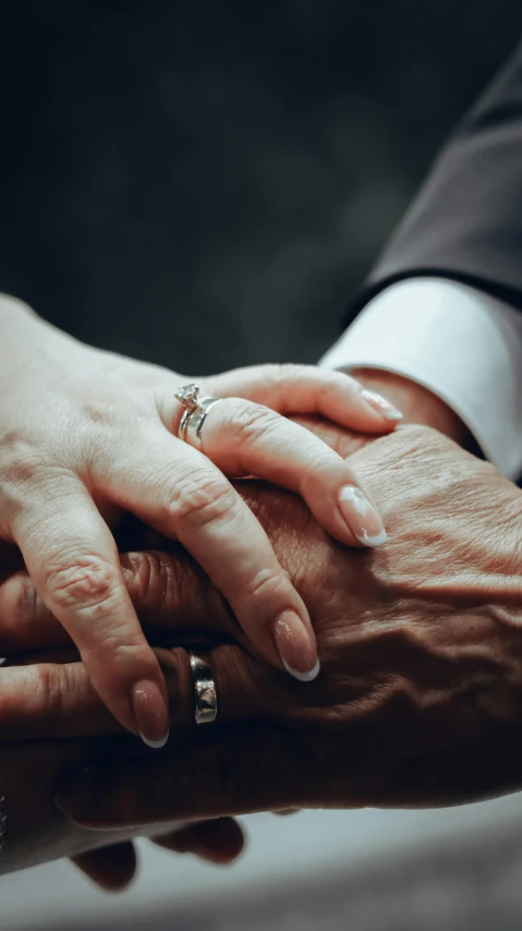 a couple's hands on top of each other