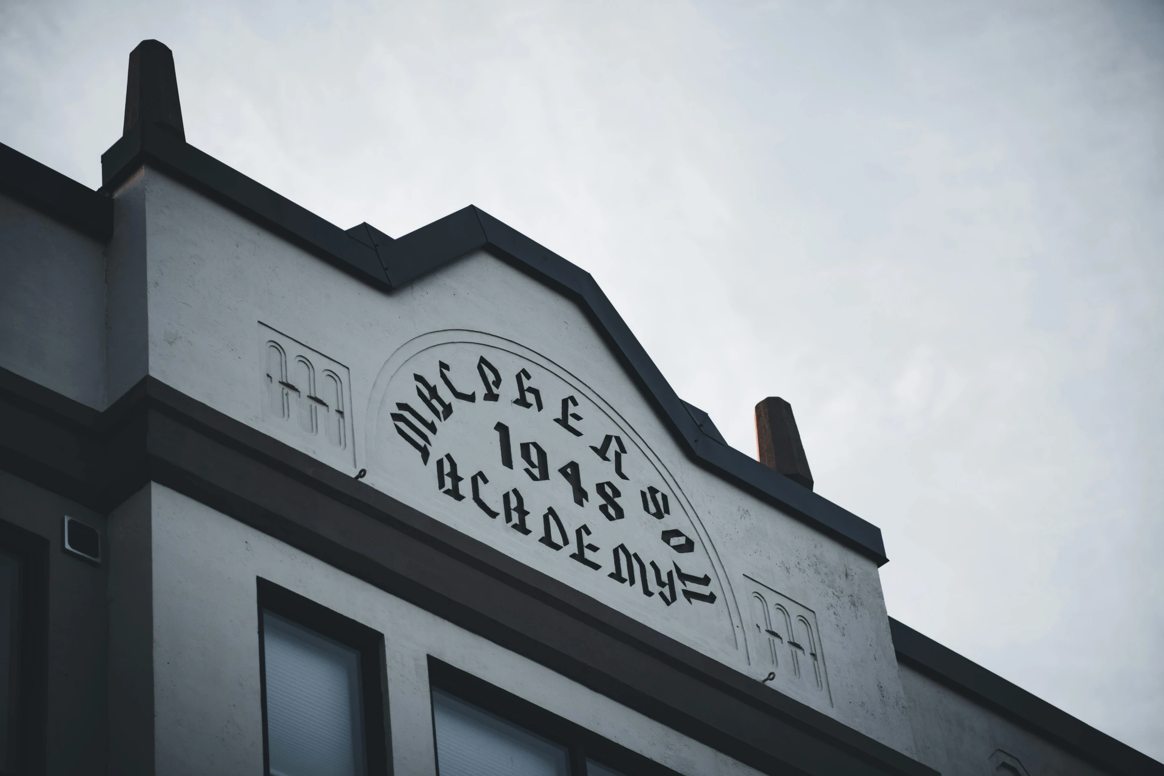 a tall gray building with writing on the side