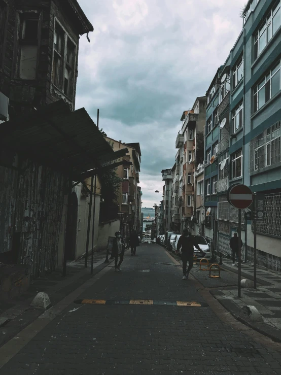 a couple of people with umbrellas are walking down the street