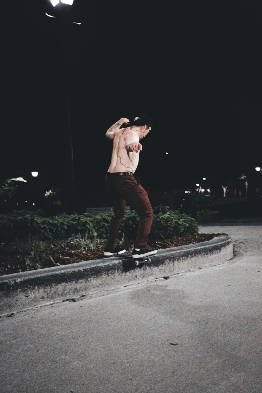 a man is on a skateboard in the street at night