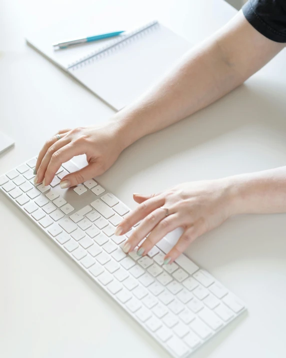 a person holding an object on a computer keyboard