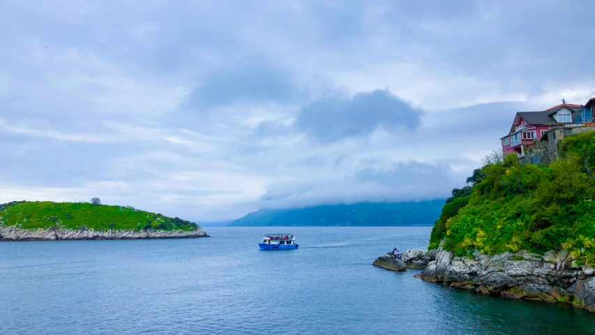 a house and boat are in the blue waters