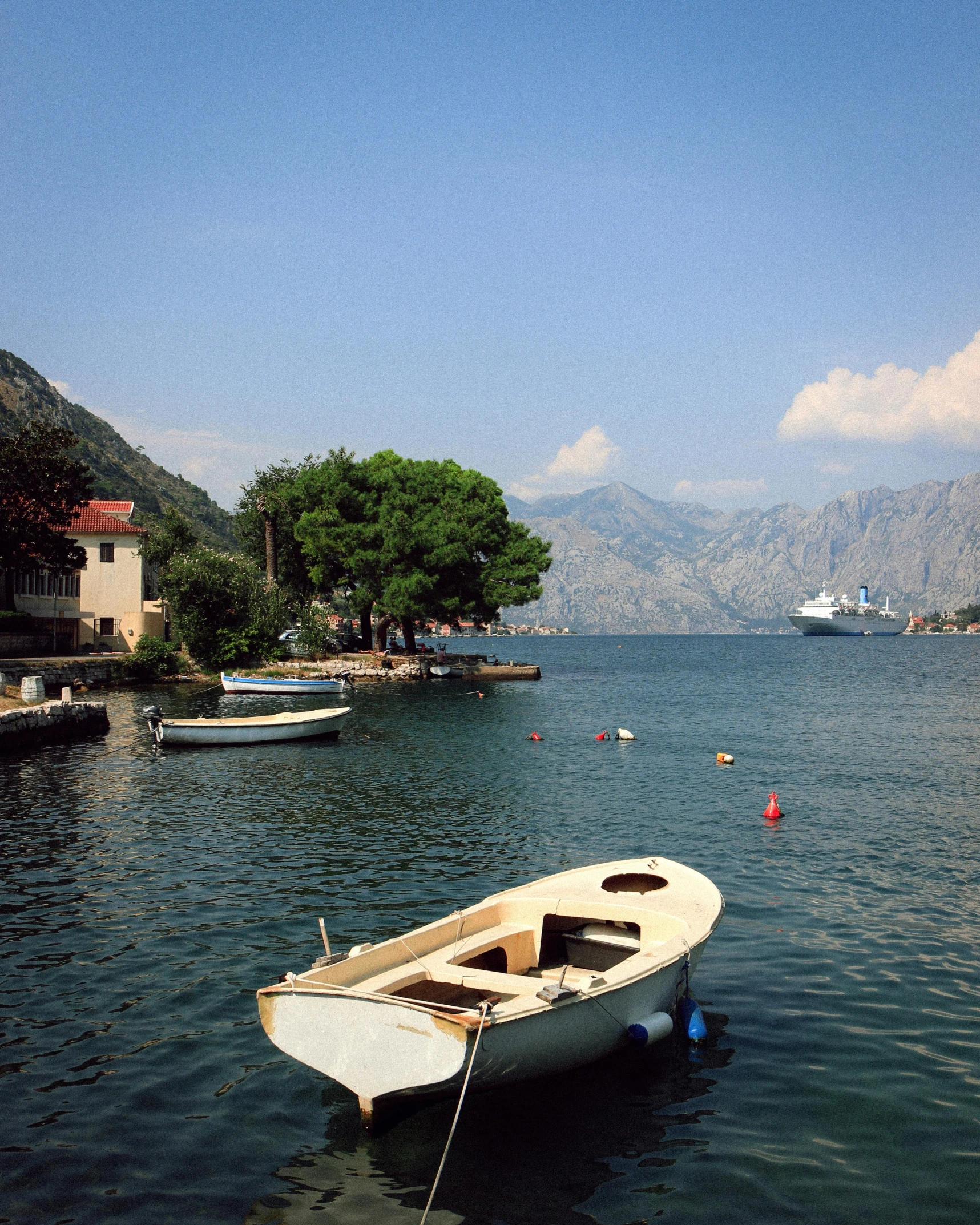 the small rowboat is anchored to the shore