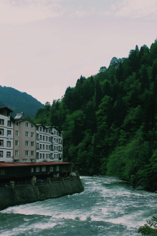 a large building sitting next to a river