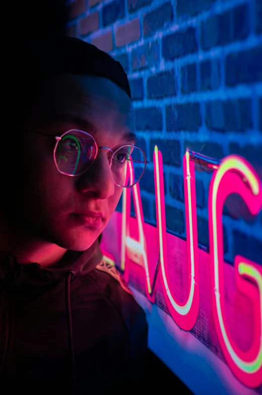 a man standing in front of a neon sign that says squat