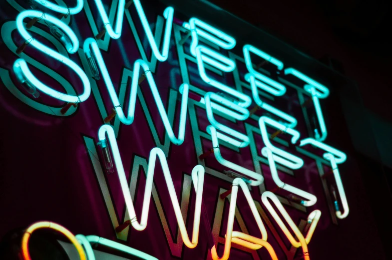 the words sweet sweet always appear neon against a dark background
