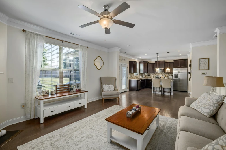 the ceiling fan is in the large living room