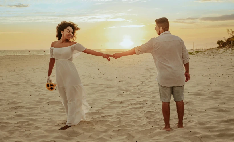 a beautiful woman walking down a sandy beach