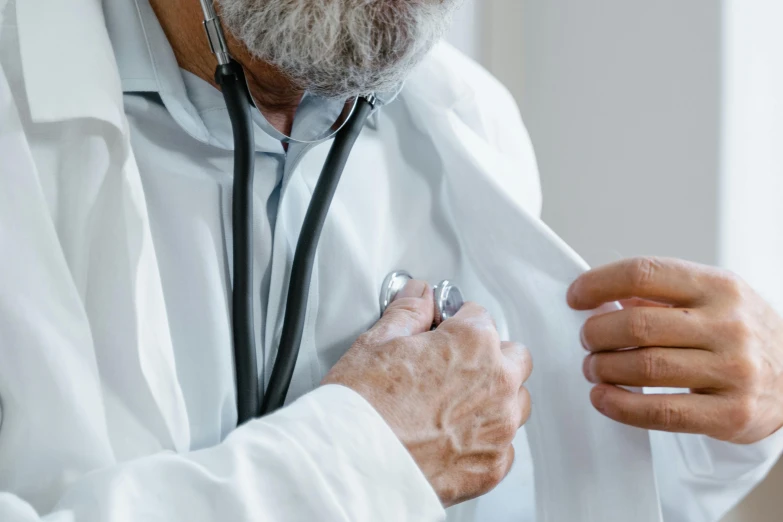 a man is wearing a doctors scrub and a stethoscope