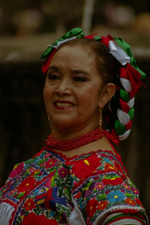 a woman is smiling in traditional dress
